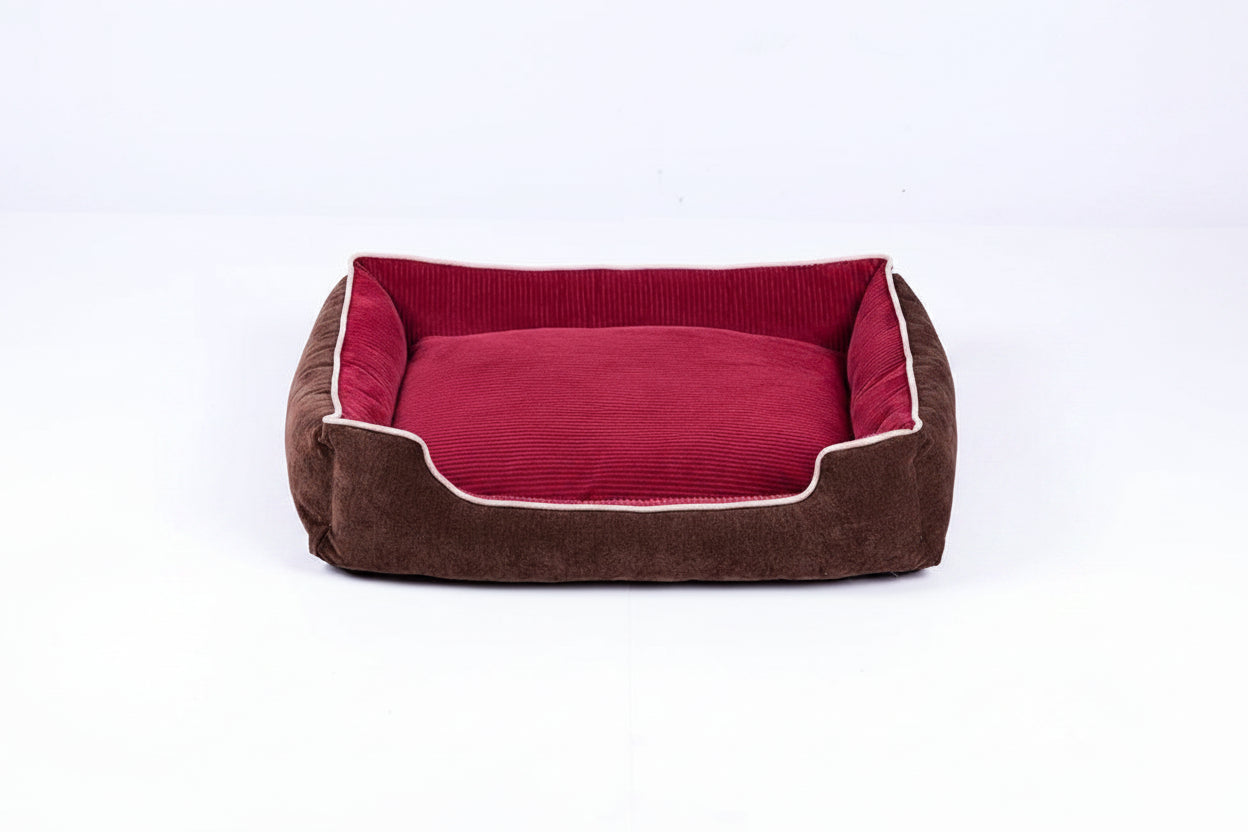 Brown pet bed with red interior on a white background