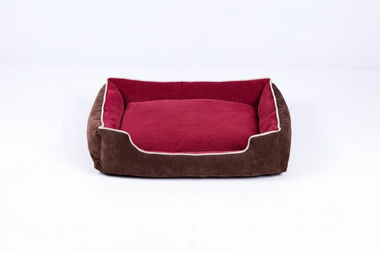 Brown pet bed with red interior on a white background