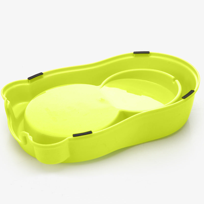Green pet bathtub with a white interior on a white background