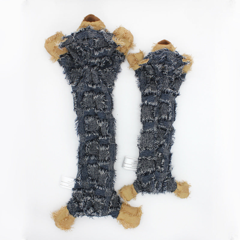 Pair of blue knitted leg warmers with brown bear paws on a white background