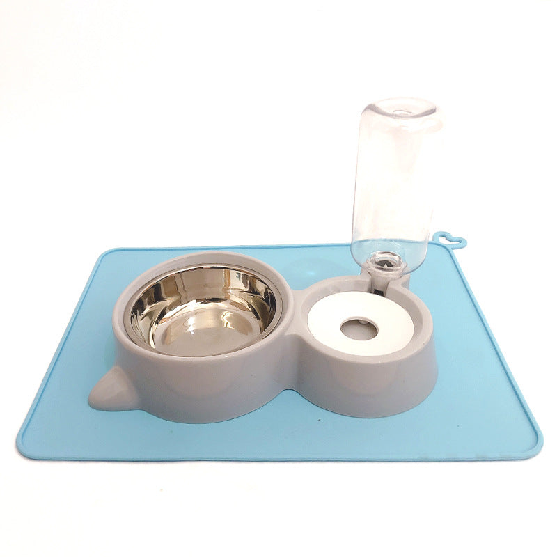 Pet feeding station with two bowls and a water bottle on a blue mat