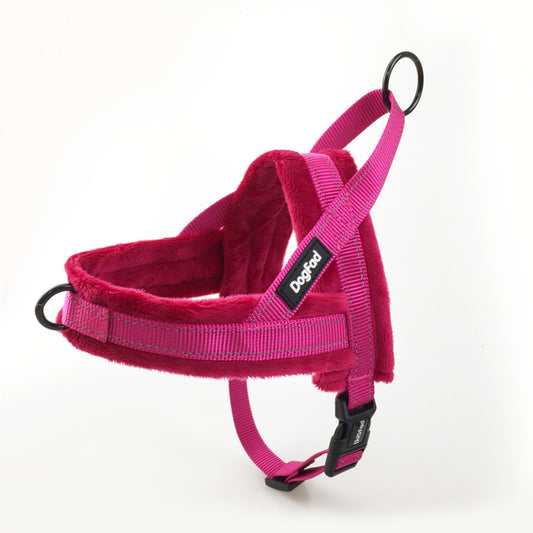 Pink dog harness with a visible brand label on a white background
