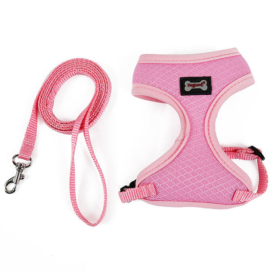Pink dog harness and leash set on a white background