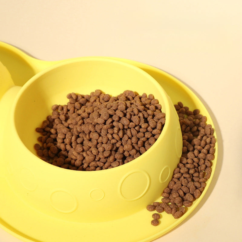 Yellow pet bowl with brown pet food on a beige background